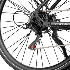 Close-up of a DUOTTS C29 Lite Electric Bike wheel with chain and gear system on a white background