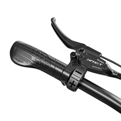 Close-up of a motorcycle handlebar with brake lever on a white background