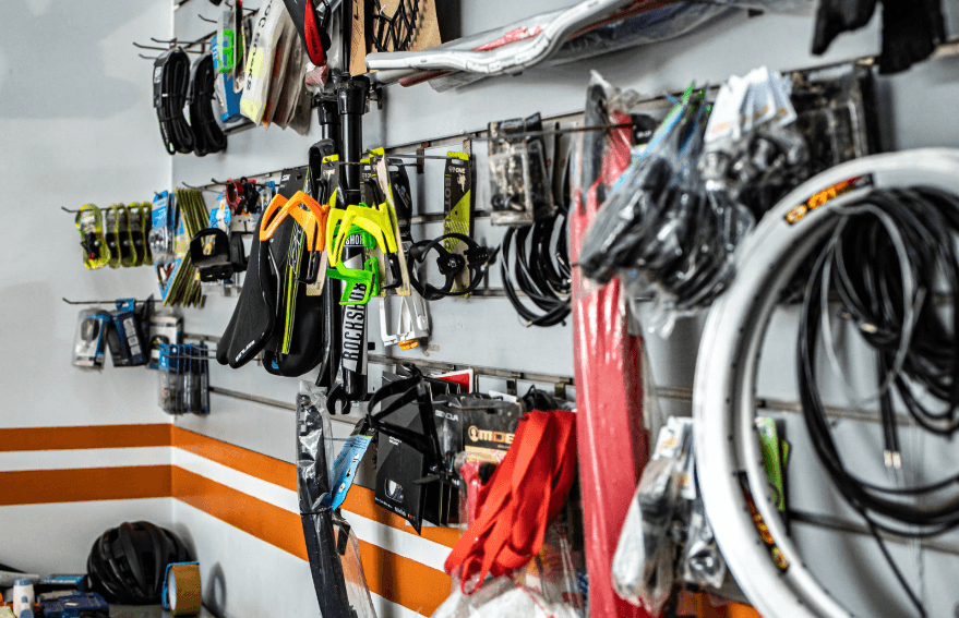 Electric bike components and accessories display wall with tires, saddles, and suspension parts