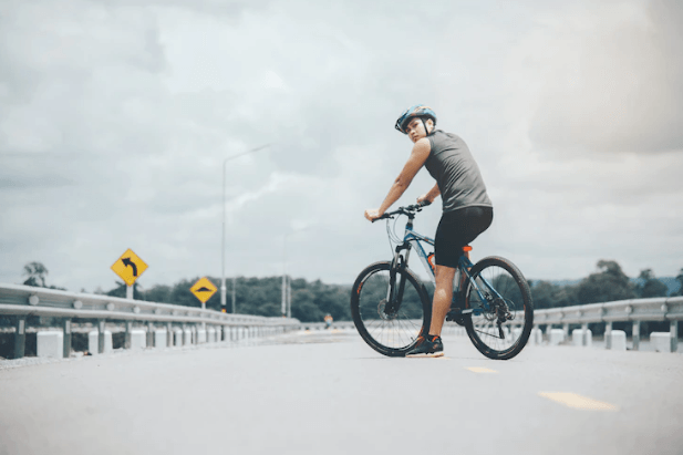 Person riding an electric bike on an open road, Pogo Cycles e-bike store lifestyle image